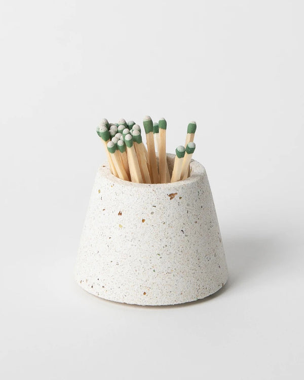 White terrazo match stick holder by Pretti Cool. Shown with green tipped matchsticks.