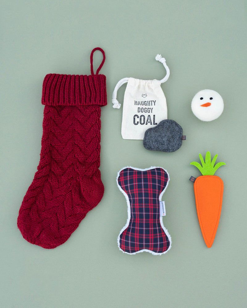 Modernbeast Red Christmas Stocking comes with naughty doggy coal, a snowman beastball, a holiday red plaid zenbone filled with lavender, and a puppy carrot filled with a squeaker.
