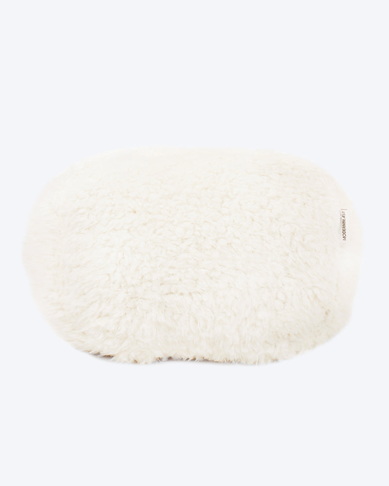 A dog bed is in ivory soft material, available in small and large sizes and made out of recycled materials.