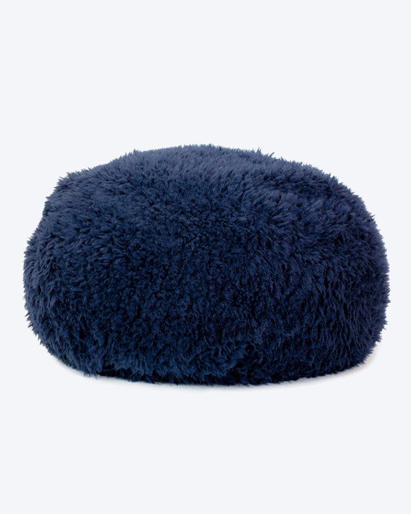 A dog bed is in navy soft material, available in small and large sizes and made out of recycled materials.