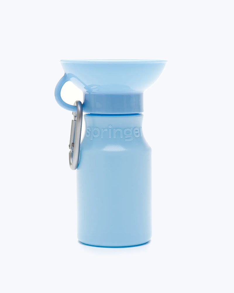 Light blue water bottle for dogs by Springer Pet. Includes a carabiner.