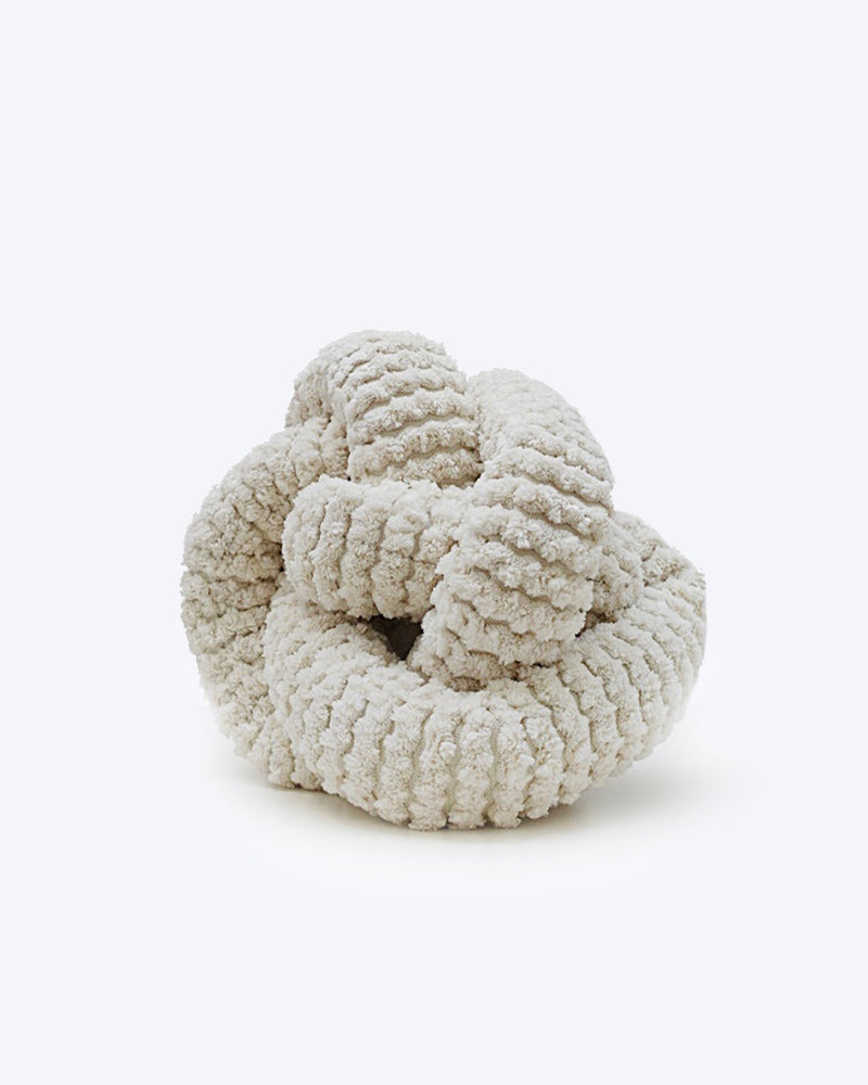 Cream corduroy NOU by Lambwolf Collective. Long rope toy tied into a knot. 